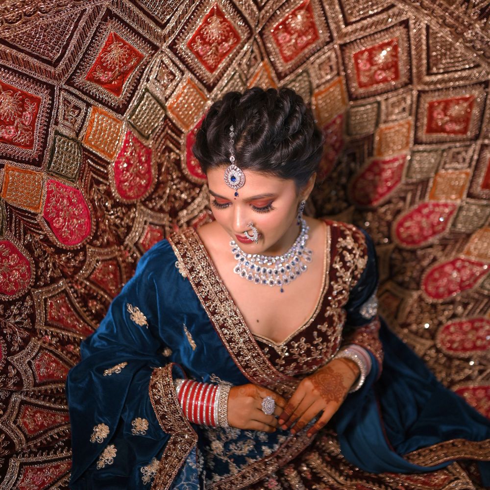 Bride in regal red lehenga with HD bridal makeup by Showstopper by Simran, Ranchi