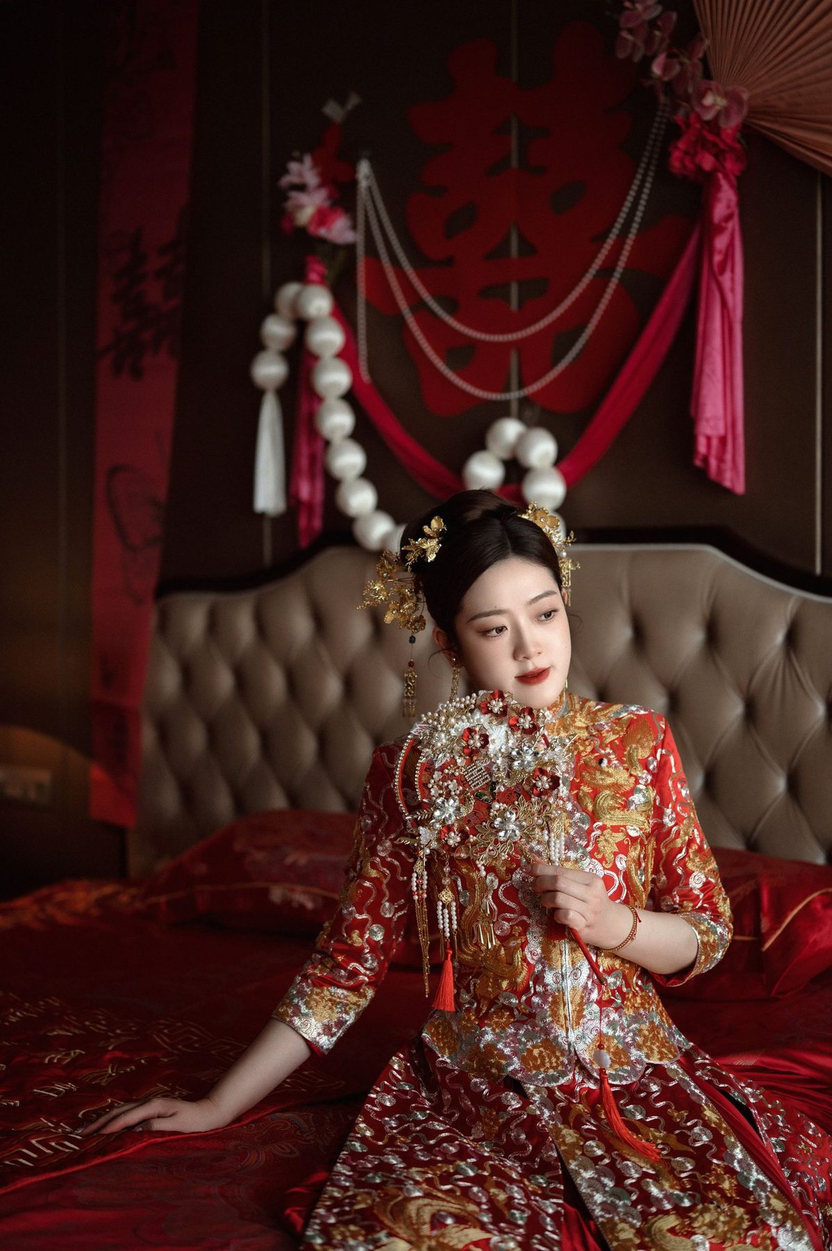Chinese bride in an embroidered red qun kwa wedding dress with refined makeup